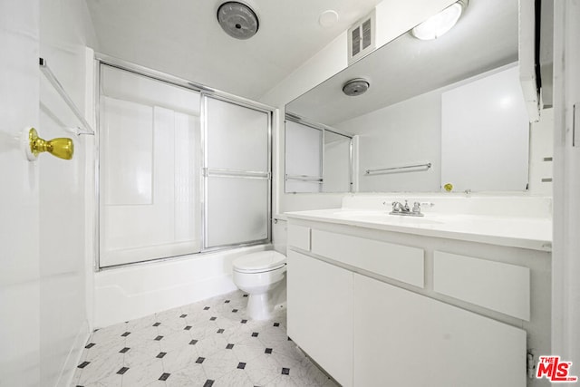 full bathroom featuring shower / bath combination with glass door, vanity, and toilet