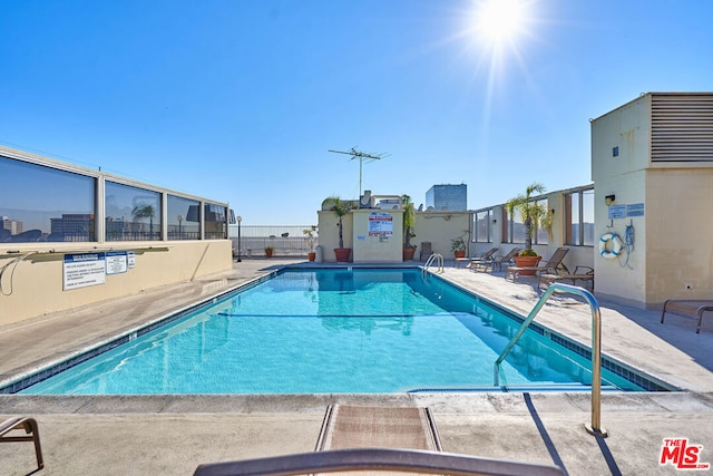 view of swimming pool featuring a patio area