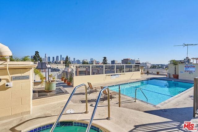 view of swimming pool with a community hot tub and a patio