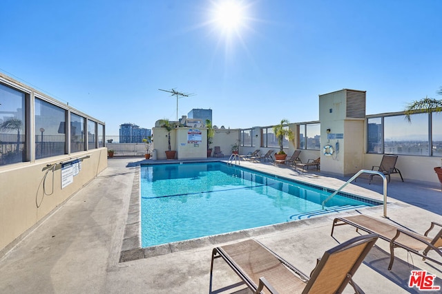 view of swimming pool featuring a patio area