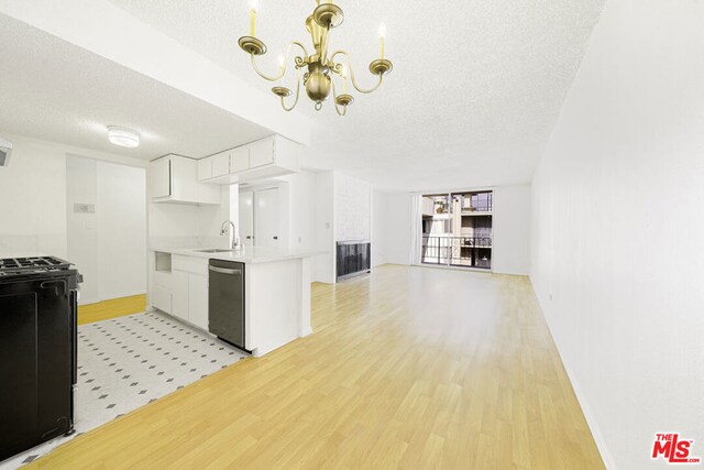 kitchen featuring white cabinetry, dishwasher, light hardwood / wood-style flooring, stove, and a textured ceiling