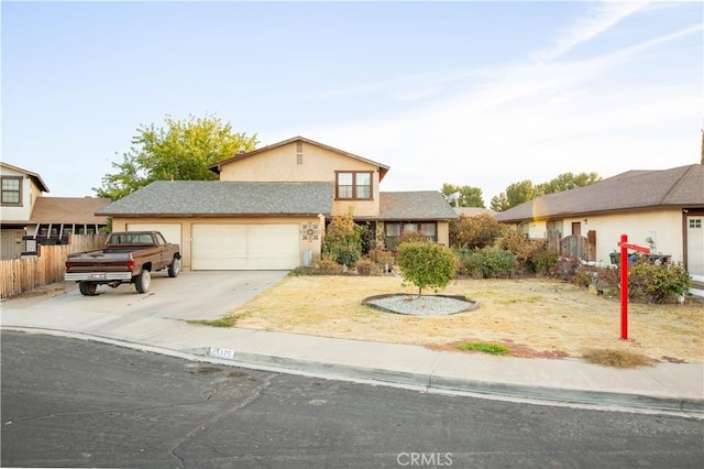 view of front of property with a garage, driveway, fence, and stucco siding