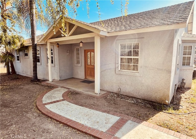 entrance to property featuring a porch