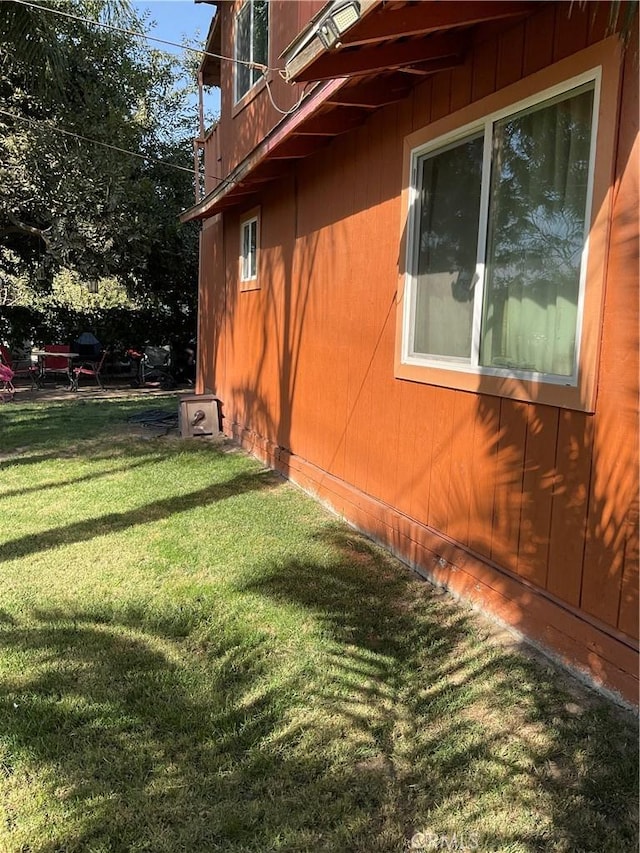 view of home's exterior with a yard