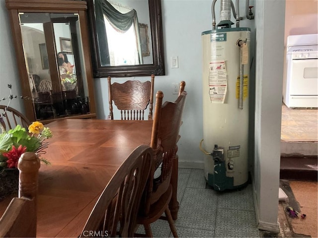 dining space with light tile patterned flooring and water heater