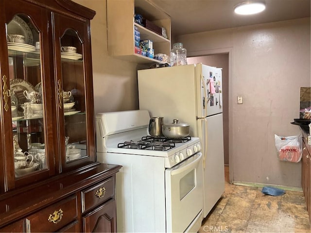 kitchen with dark brown cabinets and white gas range