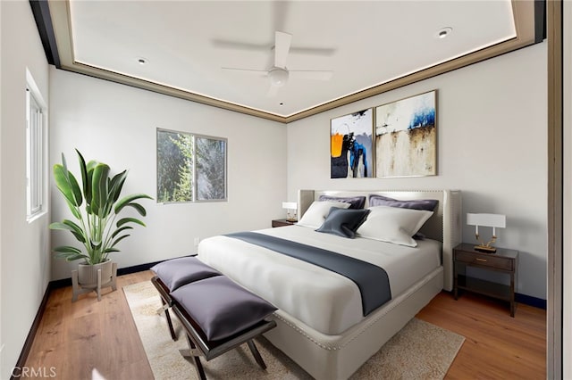 bedroom with hardwood / wood-style floors and ceiling fan