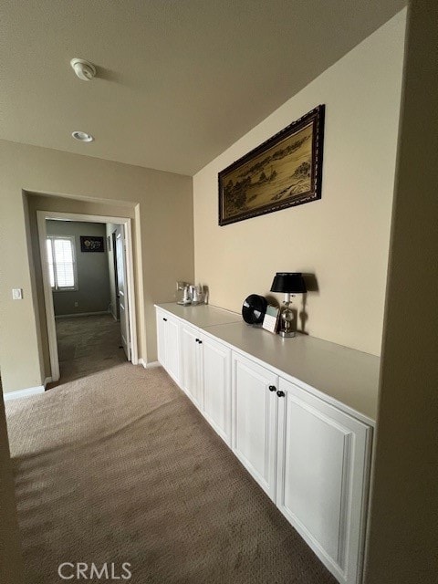 hallway featuring carpet flooring