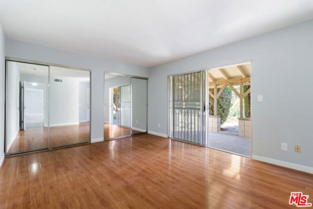 spare room featuring hardwood / wood-style floors