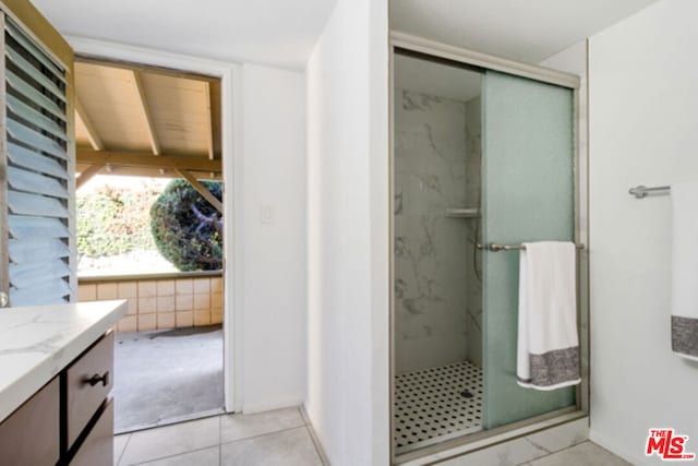 bathroom with vanity, tile patterned floors, and a shower with shower door