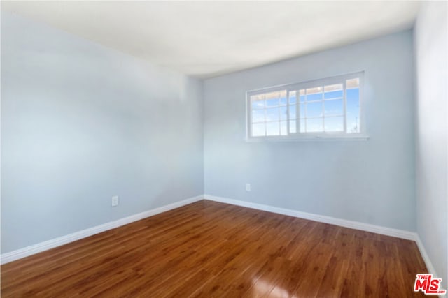 unfurnished room featuring wood-type flooring