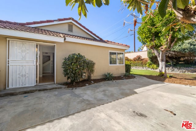 view of side of home with a patio