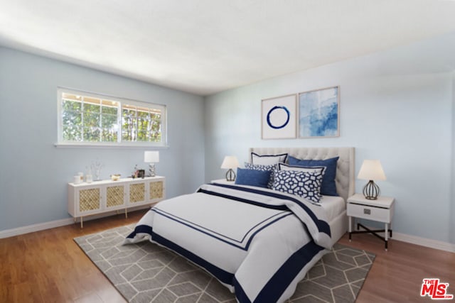 bedroom with hardwood / wood-style floors