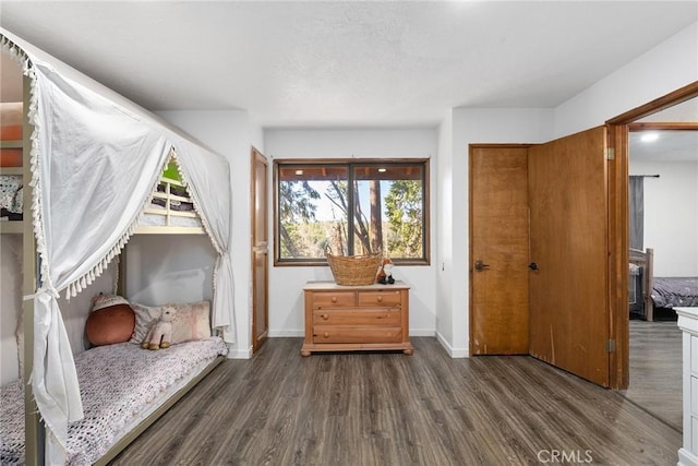 bedroom with dark hardwood / wood-style floors