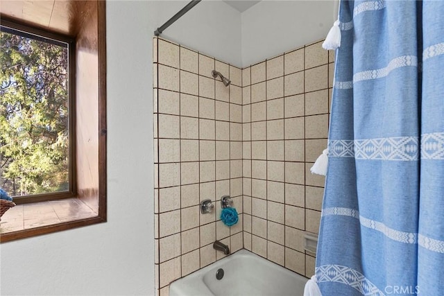 bathroom featuring shower / tub combo with curtain and plenty of natural light