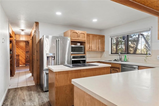 kitchen featuring a center island, sink, wood-type flooring, and stainless steel appliances