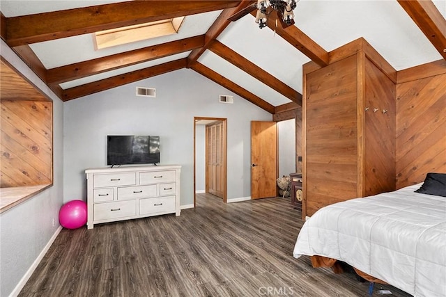 bedroom with dark hardwood / wood-style flooring and lofted ceiling with skylight