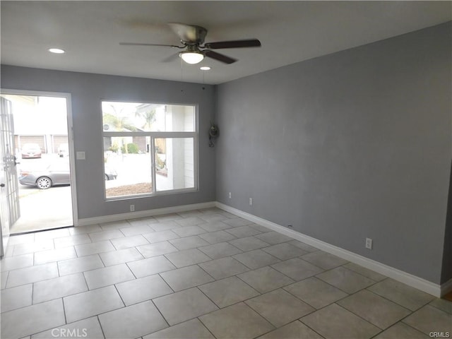 spare room with recessed lighting, a ceiling fan, and baseboards