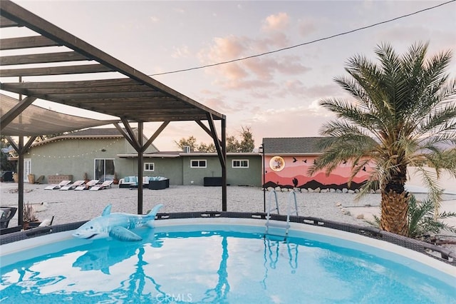 pool at dusk featuring outdoor lounge area