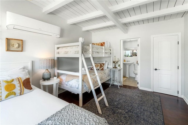 bedroom with lofted ceiling with beams, connected bathroom, dark hardwood / wood-style floors, and an AC wall unit