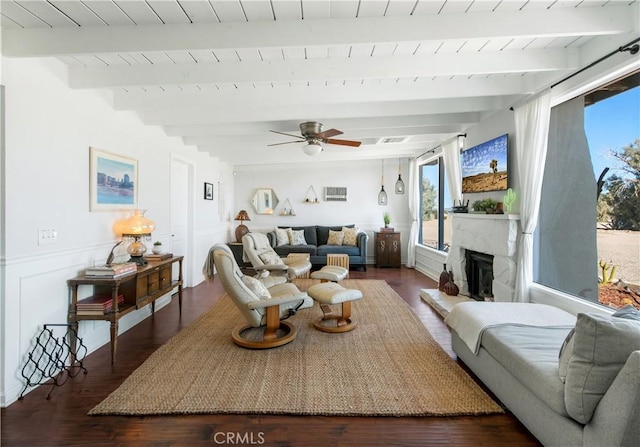 living room with beamed ceiling, dark hardwood / wood-style flooring, ceiling fan, and wood ceiling