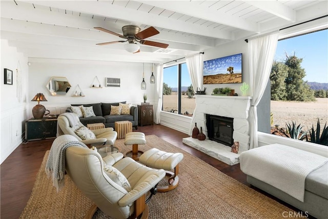 living room with ceiling fan, beamed ceiling, dark wood-type flooring, and wooden ceiling