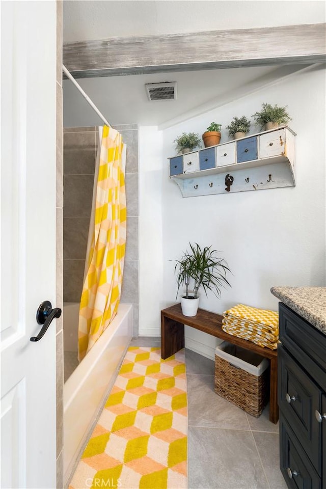 bathroom featuring tile patterned floors, shower / bath combo, and vanity