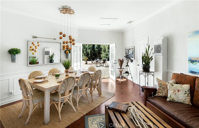 dining room with crown molding and wood-type flooring