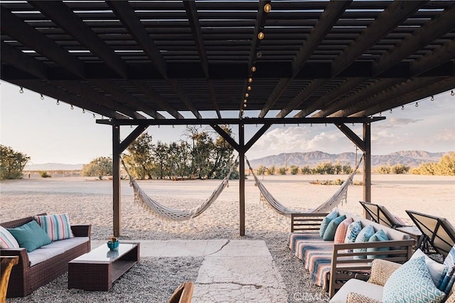 view of patio / terrace with a mountain view, an outdoor living space, and a pergola