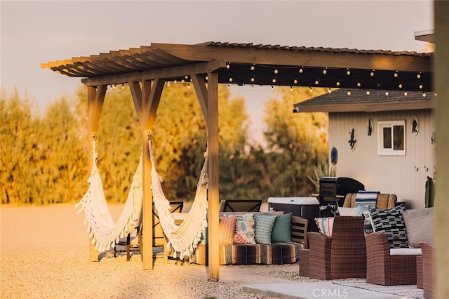 patio terrace at dusk featuring a jacuzzi and outdoor lounge area