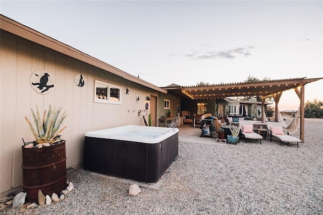 exterior space with a pergola and a hot tub