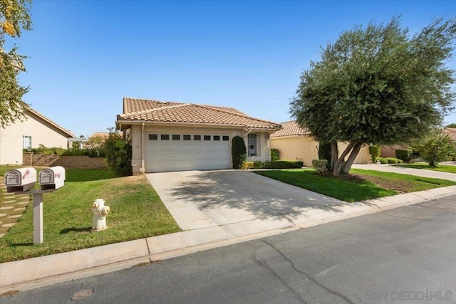 view of front of home featuring a garage and a front lawn