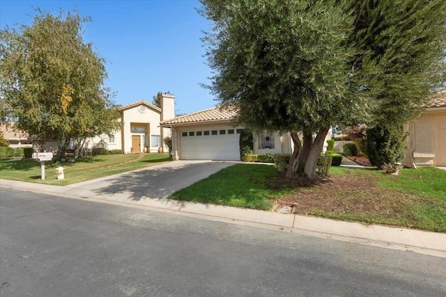 view of front of house featuring a front lawn and a garage