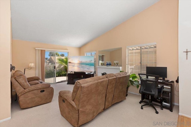 living room featuring light colored carpet and high vaulted ceiling