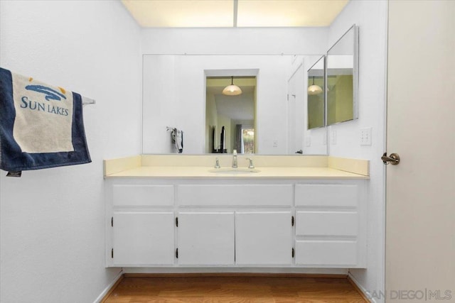 bathroom with vanity and hardwood / wood-style flooring