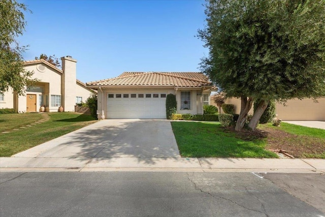 mediterranean / spanish-style home featuring a front lawn and a garage