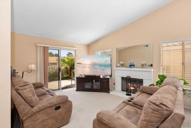 living room with light carpet, high vaulted ceiling, and a brick fireplace