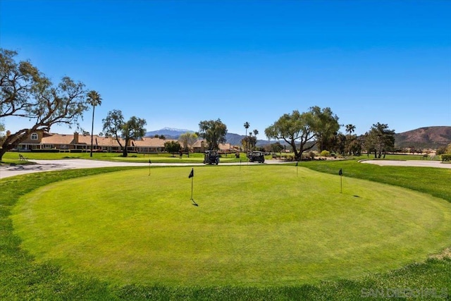 view of property's community featuring a yard and a mountain view