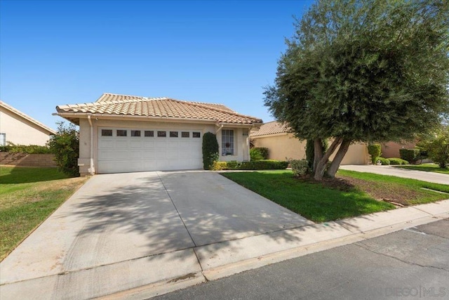 view of front of house featuring a front yard and a garage