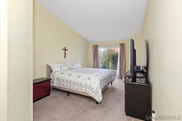 carpeted bedroom featuring lofted ceiling