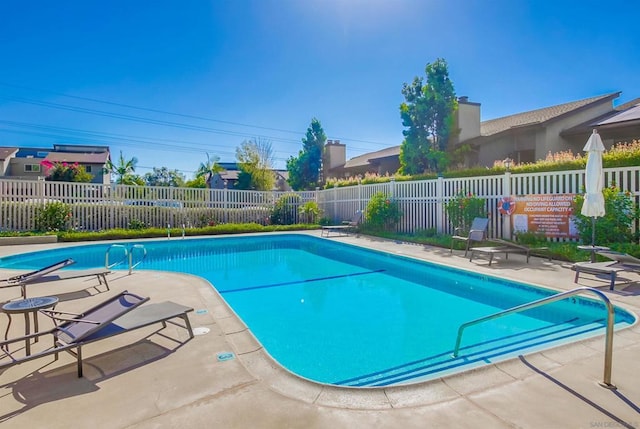 view of swimming pool with a patio