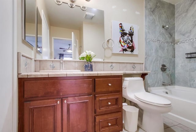 full bathroom featuring ceiling fan, tile patterned floors, toilet, vanity, and tiled shower / bath