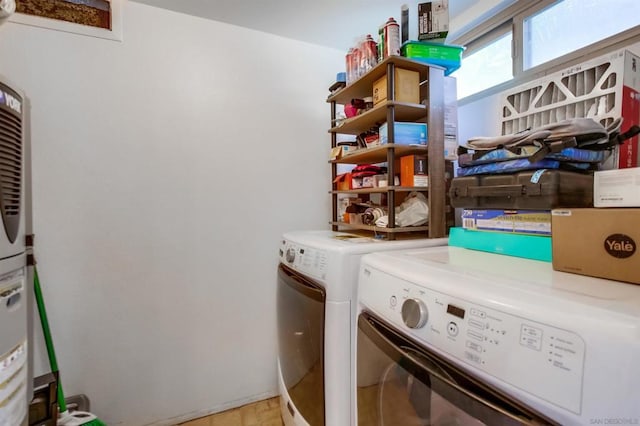 clothes washing area with separate washer and dryer and light hardwood / wood-style flooring