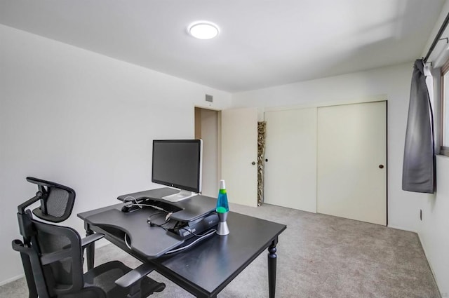 office area featuring light carpet