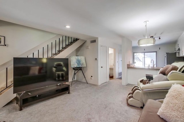 carpeted living room featuring sink