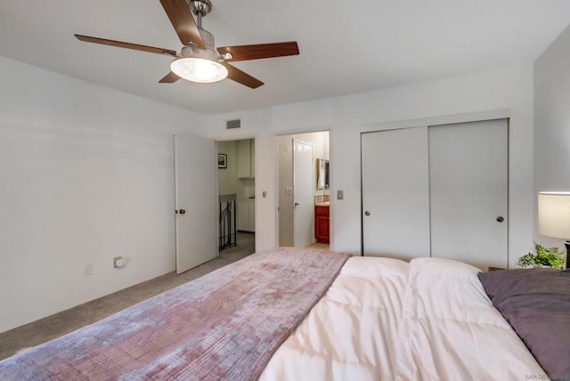 carpeted bedroom featuring a closet and ceiling fan