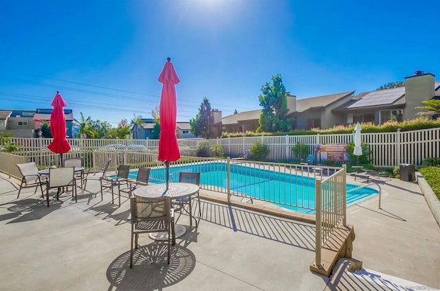 view of swimming pool with a patio