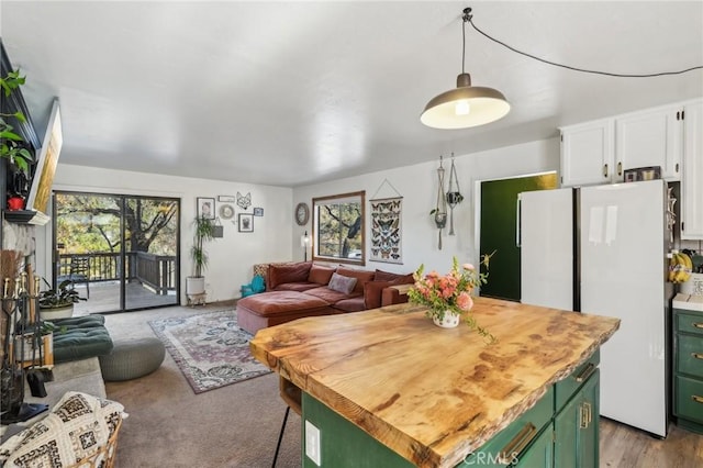 kitchen featuring white cabinets, white fridge, plenty of natural light, and green cabinetry