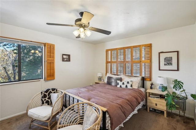 carpeted bedroom with multiple windows and ceiling fan