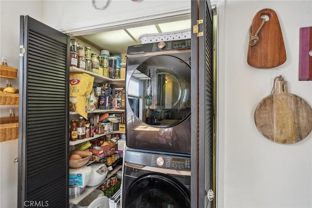 clothes washing area with stacked washer / drying machine